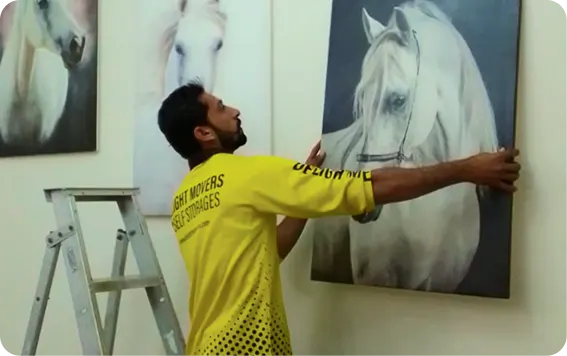Mover packing framed artwork for an overseas move from Abu Dhabi