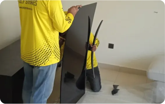 Villa movers packing furniture in protective wrap in Abu Dhabi