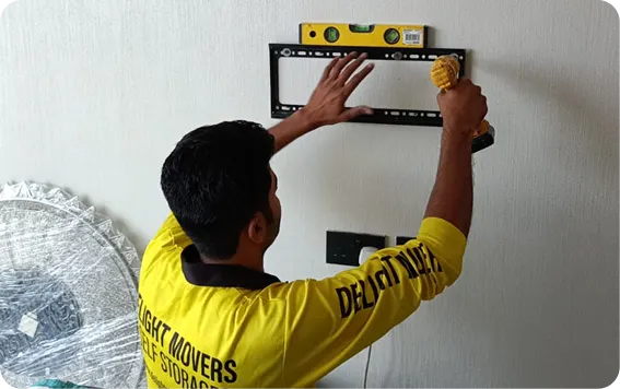 Delight mover installing a TV wall mount in a new villa