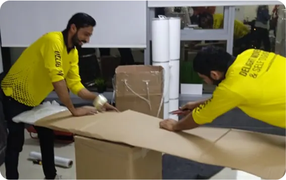 Delight movers packing household items for an apartment move